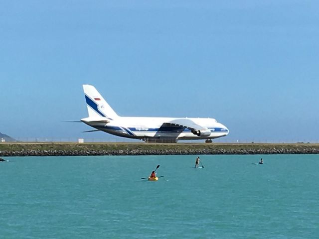 Antonov An-12 — - Photo taken 24 NOV 18 from Hickam Beach of an AN-124 (VDA1446) rolling to Runway 8R, departing HNL for GUM.