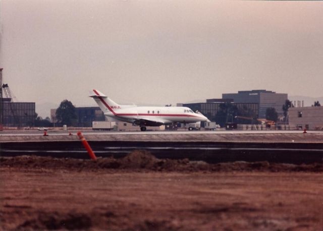 Piper Seneca (N141JL) - 1969 Hawker Siddeley DH.125-400A at Santa Ana in the 1980s