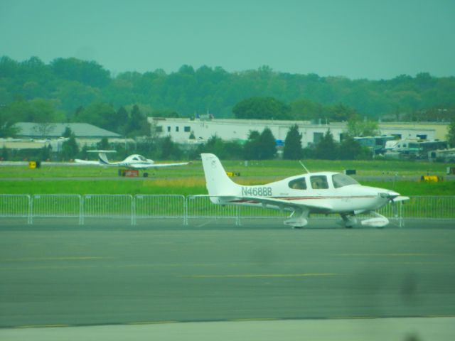 Cirrus SR-20 (N468BB) - A Cirrus SR-20 Parked On The Ramp At Manassas Reginal, In The Background Is N136MA, A Dimond DV-20