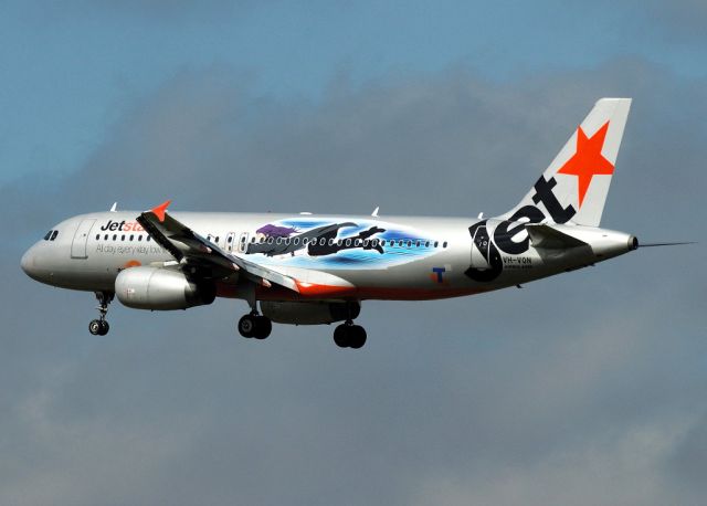 Airbus A320 (VH-VQN) - No its not a witch, it was supposed to be a person flying along with the quick, 2010 version of the next GEN3 phone service and internet speed provided by Telstra Australia. It did not go well and the livery only lasted a month or so.