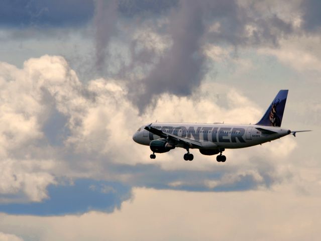 Airbus A320 (N209FR) - Clouds trying to rain. Sweet short-final approach shot