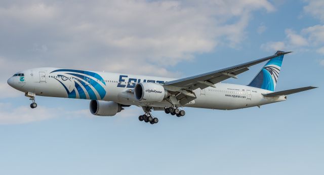 BOEING 777-300ER (SU-GDO) - MSR995 arrives from Cairo in the shadows of some passing clouds! Short finals for runway 23