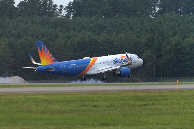 Airbus A320 (N195NV) - I was standing near the fence by the Maine Air Museum. I pressed the camera lens against the fence and got this shot. 