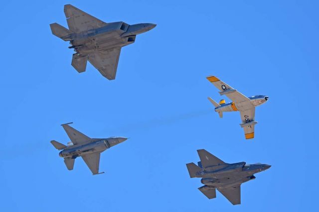 Lockheed F-35C (14-5095) - North American F-86F Sabre NX186AM, Lockheed-Martin F-35A Lightning II 14-5095, Lockheed-Martin F-22A Raptor, and Lockheed-Martin F-16CJ Block 50 Fighting Falcon 01-7050 participating in the Air Force Heritage Conference at Davis-Monthan AFB on March 4, 2018.