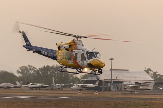 Bell 412 (VH-EPR) - Bell 412 departing YBRK late afternoon with bushfire smoke smothering the setting sun.