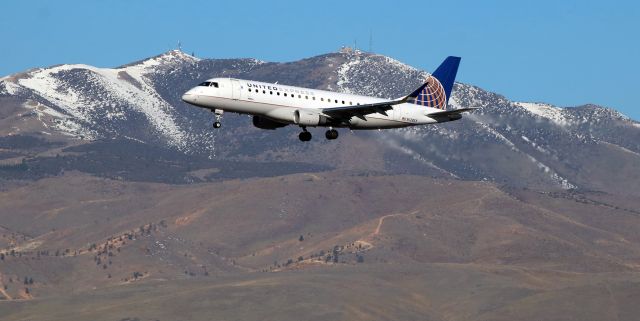 Embraer 175 (N128SY) - On a midmorning (8:30 AM) approach to Runway 16R, this United Express (SkyWest) E75L comes past Peavine Mountain which is still a bit white at the top but getting green near the base.br /SKW's N128SY was arriving from SFO.