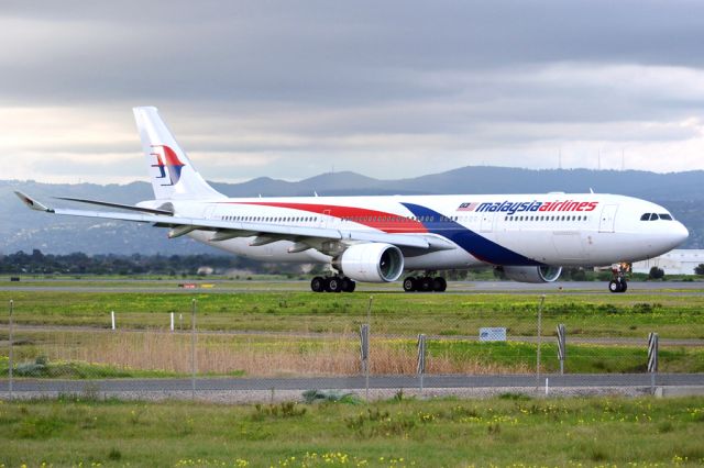 Airbus A330-300 (9M-MTC) - On taxi-way heading for take off on runway 05, for flight home to Kuala Lumpur, just before the arrival of a rain storm. Thursday 12th July 2012.