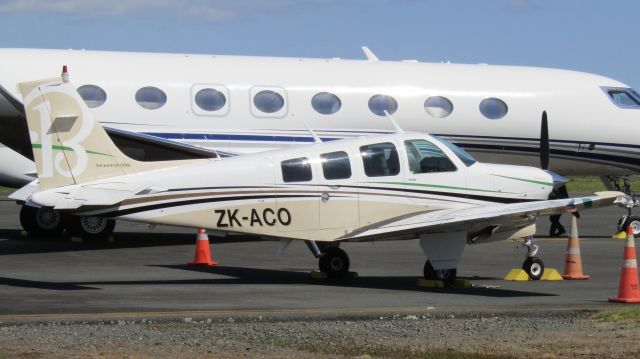 Beechcraft Bonanza (36) (ZK-ACO) - Air Centre One's baby girl seeing some sun while the whole fleet from hangar 6 gets some exercise in the form of engine runs; or in ACO's case, a test circuit. The registration behind the Bonanza is VP-CJR.
