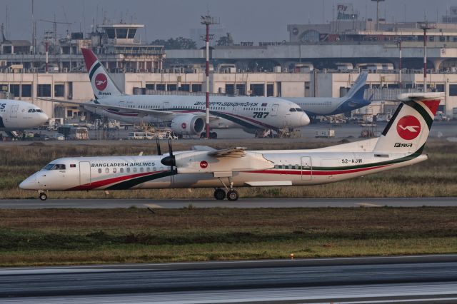 de Havilland Dash 8-400 (S2-AJW) - 27th December, 2024: Exiting runway 32 via November 2 after the flight from Chottogram's Shah Amanot International Airport to Dhaka's Zia International Airport. Biman's first Dreamliner, S2-AJS, is seen in the background. 