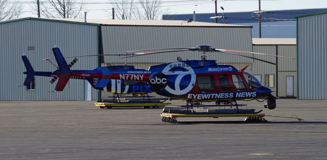 Bell 407 (N77NY) - LINDEN AIRPORT-LINDEN, NEW JERSEY, USA-JANUARY 07, 2021: News helicopters from two of the local New York City television stations are seen on the ground after completing their first flights of the morning.