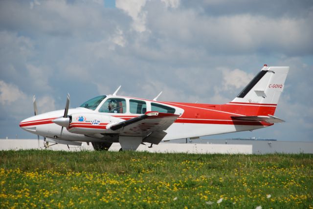 C-GOVQ — - Magaret at the controls of her Twin Beech Bonanza, doing her preflight at Buttonville Airport, near Toronto.