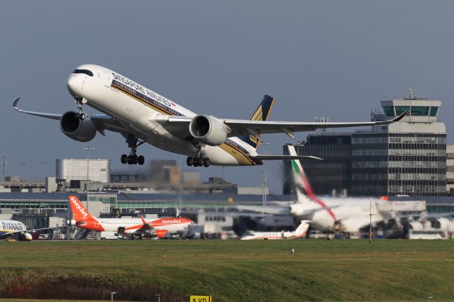 Airbus A350-900 (9V-SMH) - SIA51 departing on the long flight back to Singapore with the little and large of the Airbus family in the background.