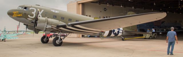 Douglas DC-3 (N47TB) - TAB being pushed out of the hanger for a moment while other workers reposition another plane behind it.