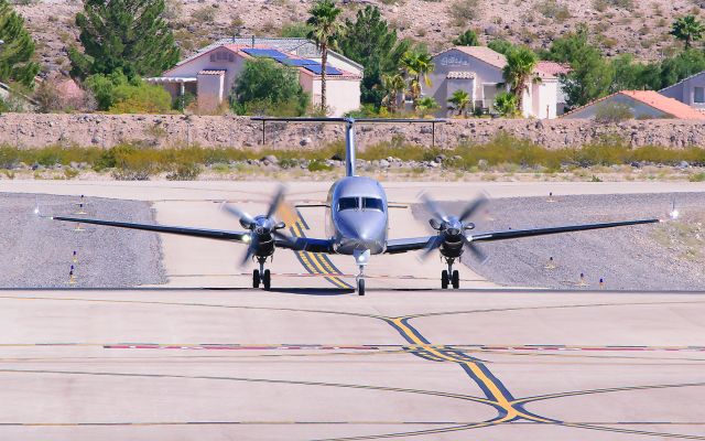 Beechcraft 1900 (N690MA) - One of Maverick Airlines 1900Ds returning from a flight! I was able to catch both wingtip strobes!