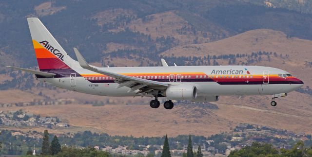 Boeing 737-800 (N917NN) - Making only its second visit to Reno since being unveiled over ten months ago, Americans N917NN, dressed in colorful AirCal heritage clothes, glides over the Meadowood neighborhood as it covers the final 1000 feet of its approach to RTIAs runway 34L.  br /The single previous visit by this heritage-schemed fleetbird was seven months ago, in February, and on that occasion it arrived at night (around 8:30 PM) and departed again before dawn, so very few people had an opportunity to see it.  Yesterdays arrival came under cloudy skies but at least it was at midmorning so the light conditions were sufficient for this click, and by the time it departed a few minutes after high noon the sun had come out and the lighting was fine.