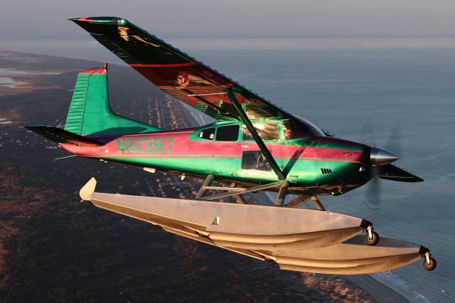 N61387 — - As the sun slowly sets, the Skywagon amphibian flies majestically over the mid-Atlantic.  