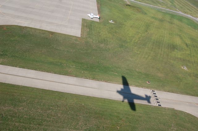 Ford Tri-Motor (NAC8407) - Shadow of the EAA Ford Tri-Motor in flight over Lees Summit, MO airport on 9-11-11.