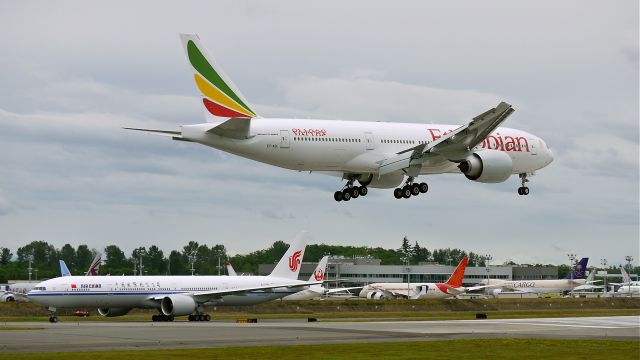 Boeing 777-200 (ET-AQL) - BOE106 from KARA on final to runway 16R on 6/27/13. (LN:1115 cn 43814).  The aircraft was returning after having been painted. BOE164 is holding on the taxiway.