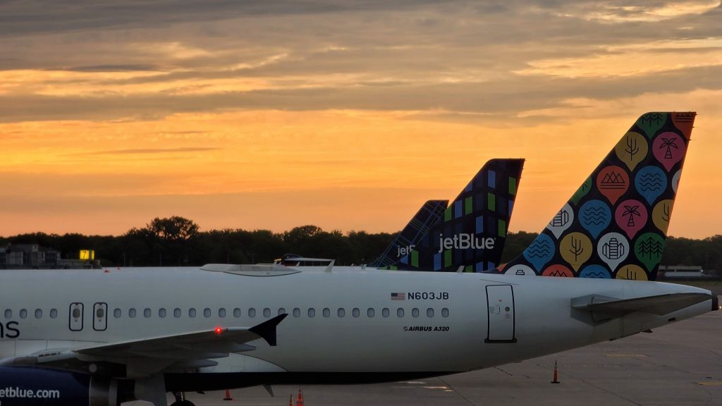 N603JB — - Row of A320s awaiting pushback against the sunrise in Windsor Locks. View from Departure Lane on May 21, 2021.