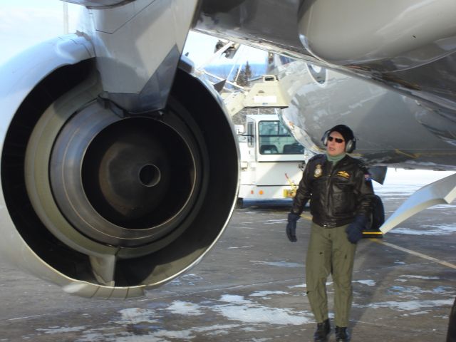 — — - A crew member of a brand new Boeing 737NG delivered to the R.A.A.F. does a walkaround in Fort McMurray, Alberta, Canada during a stopover February 22, 2007