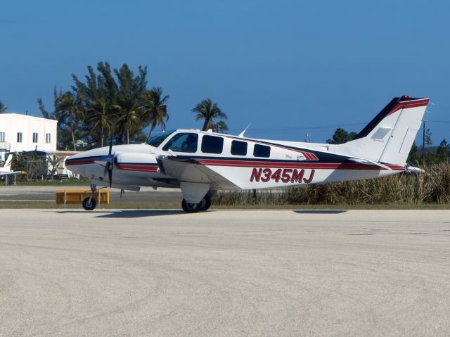 Piper Cherokee Arrow (N345MJ) - A very nice Baron at Nassau. Note the aircondition scoop on the left engine.