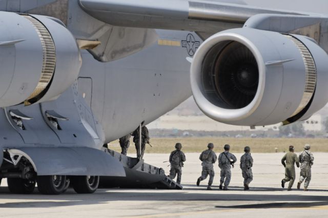 — — - US soldiers disembarking from a C-17 Globemaster III during a cargo drop demonstration at the 2012 March Field Airfest in Riverside, California