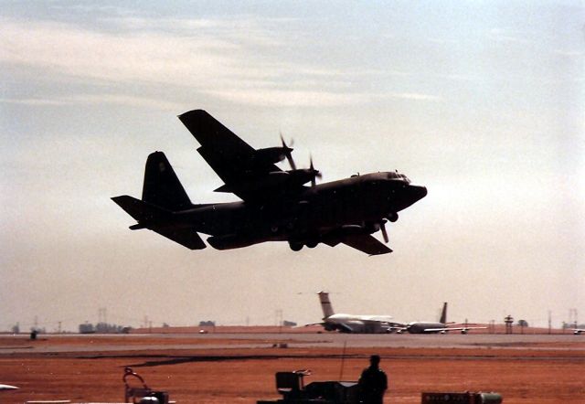 Lockheed C-130 Hercules — - KSUU - US AIR FORCE C-130 on final does a LAPES - Low Altitudes Pallet Extraction System Demo during the Travis AFB Airshow - 1987. I missed photo 2 because they dropped down so low I could not see them. Plus I thought they crashed and I was gonna start running. This photo shows the C-130 banking out to climb as they had deployed the LAPES perfectly. The dust and dirt made it looked like they crashed.