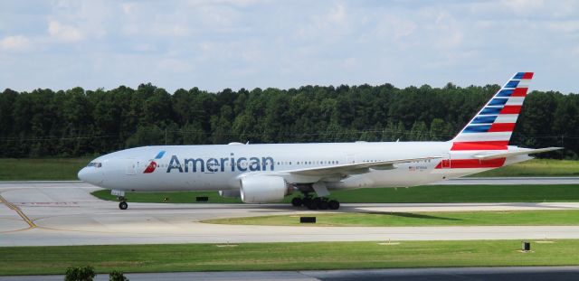 Boeing 777-200 (N795AN) - A sunbeam lights up the tail of N795AN on a windy day at RDU, 8/26/17.