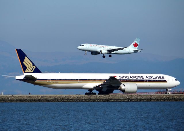 BOEING 777-300 (9V-SWE) - Singapore holding short while Air Canada Lands on RWY 28R