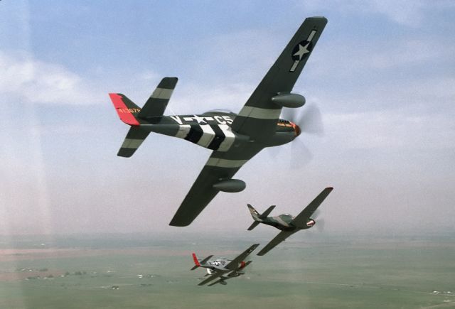 — — - A flight of P-51 Mustangs turning in for a low pass over Beale Air Force base.