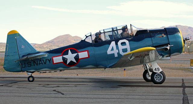 North American T-6 Texan (N2983) - Displaying two different race numbers (Race 48 on the fuselage but Race 49 on the landing gear well cover), "Playtime," a North American T-6G Texan (N2983), is captured as it taxies past me heading toward Runway 26 for takeoff.