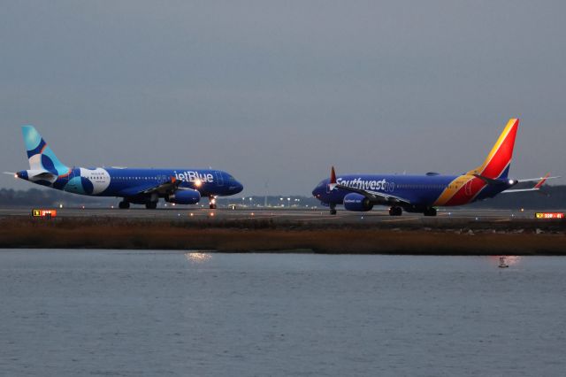 Airbus A320 (N629JB) - Jet Blue A320 in new/updated livery about to depart BOS followed by competitor Southwest on 10/25/23. 