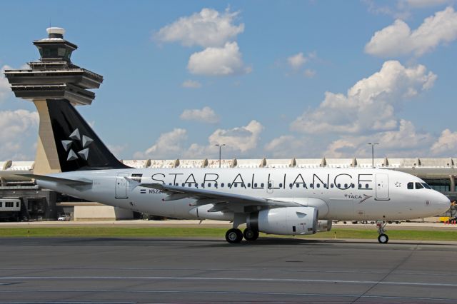 Airbus A319 (N522TA) - TAI590 arriving into IAD passing the main terminal.