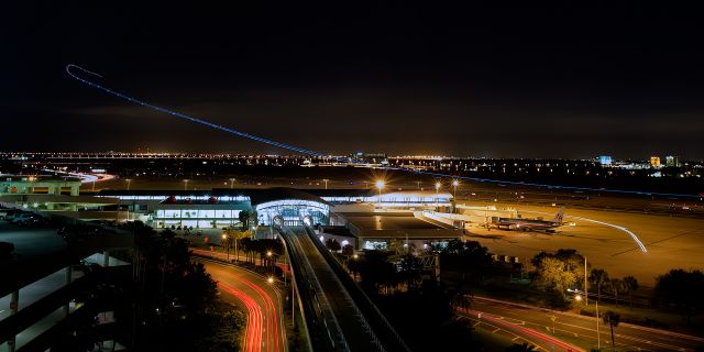 Boeing 737-800 (N8660A) - Outbound to New Orleans from 19R doing the standard noise abatement procedure, 1 minute exposure. Best seen at full size.