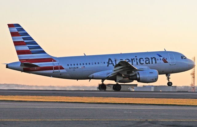 Airbus A319 (N748UW) - RWY27 sunset landing @ KBOS Logan