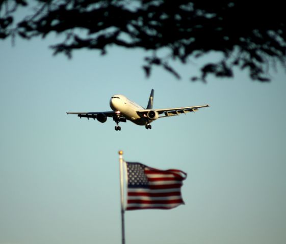 N135UP — - On Final 30L, UPS competes for flying attention with "Old Glory"