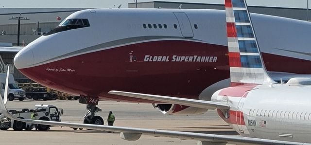 Boeing 747-400 (N744ST) - Global Super Tanker firefighting plane landed about an hour ago at San Antonio International Airport.  Image taken facing ST Engineering hangars from nearby parking garage.