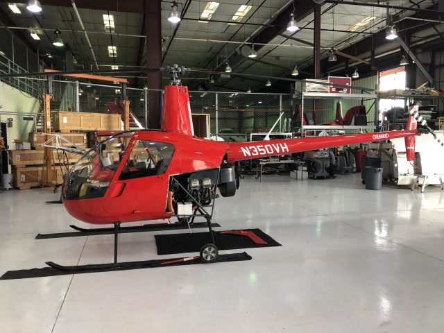 Robinson R-22 (N350VH) - Standing in the hangar of this helicopter while it’s being serviced.