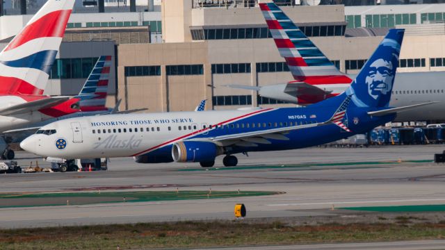 Boeing 737-800 (N570AS) - Painted in the Honoring Those Who Serve Livery. Tail tto the left is British Airways 777-300ER G-STBJ. Tail to the right is American Airlines 777-300ER N736AT.
