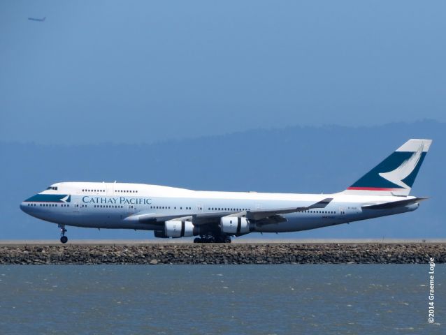 Boeing 747-400 (B-HUG) - From the shoreline parallel to 28L/R at SFO, taken on August 31, 2014.  Flight CX870, the last scheduled passenger carrying Boeing 747 into North America,  by Cathay Pacific Airways. On September 1, 2014, all North American passenger flights by Cathay Pacific will be serviced by Boeing 777-300ERs.  br /br /Note the Southwest Airlines 737 taking off from OAK in the upper left corner.