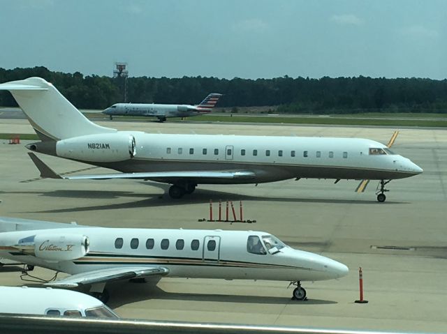 Bombardier Global Express (N821AM) - Bombardier Global Express parked on the tarmac outside the General Aviation terminal at Raleigh-Durham International. Photo taken 13 August 2019