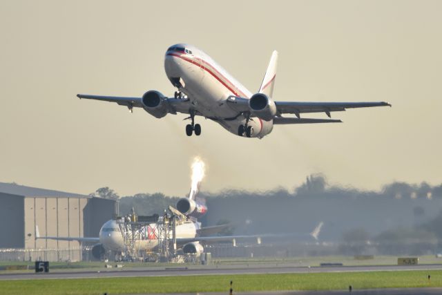 BOEING 737-400 (N730CK) - That sun hitting the vertical stab on that FDX MD-11F in the background looks like it is on fire!