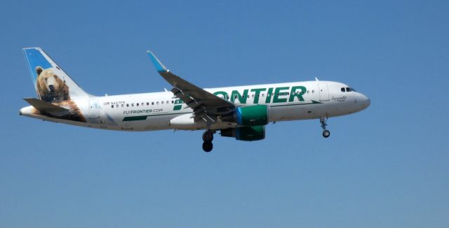 Airbus A320 (N227FR) - Shortly after departure is this 2014 Frontier Airlines Airbus A320-214 with "Grizwald" the Bear enjoying the tail view in the Spring of 2021.