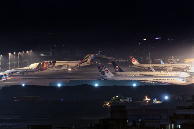 BOEING 777-300 (S2-AHN) - 18th October, 2020: Night time overview of the ramp at Dhaka's Zia International Airport in the middle of the global COVID-19 pandemic. Most civil aviation flights are suspended but a few Middle Eastern operators continue to serve Dhaka with mostly cargo and a few passenger flights. Foreground shows the new terminal under construction while background shows several hangers being built in the north by Joshimuddin Road perimeter wall where existing general aviation will be relocated. (See http://www.planexplorer.net/Xploregallery/displayimage.php?pid=1679 )