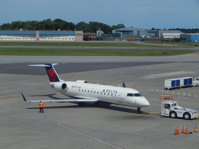 Canadair Regional Jet CRJ-200 (N8971A) - A Delta CRJ200 is pushed back from KALB.