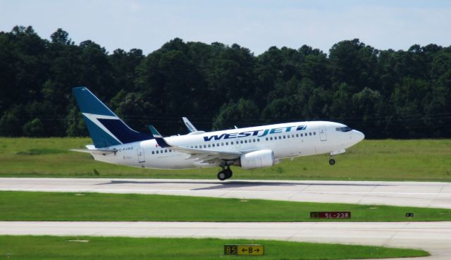 Boeing 737-700 (C-FJWS) - Not my best shot... HOWEVER! WestJet at RDU! A medical diversion sent this YYZ-FLL flight to here.  Managed to catch departure.  Very cool.