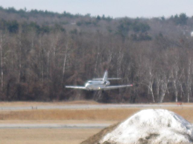 Cessna Citation Sovereign (N377QS) - Approximately 2.8 seconds from touching down on runway 14. These Sovereigns stop amazingly fast!! You can see how snow-deprived we are here in the Northeast this winter (2011-2012).