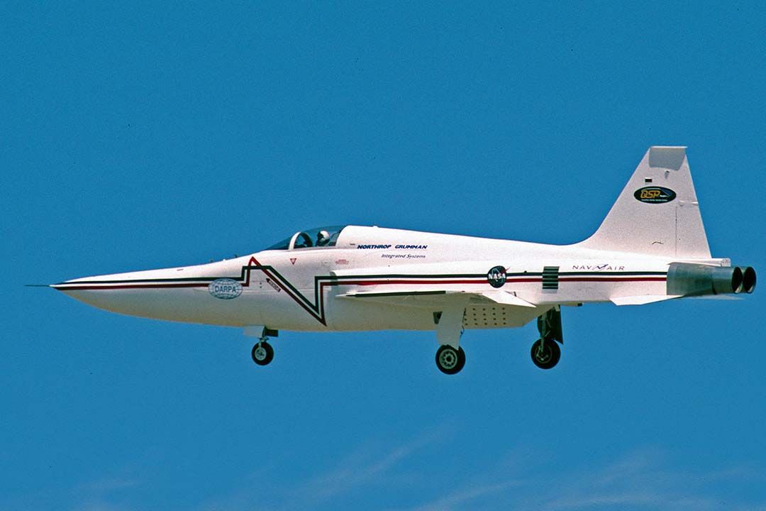 Northrop RF-5 Tigereye (74-1519) - The F-5 Shaped Sonic Boom Demonstrator (SSBD) made a flight from Air Force Plant 42 at Palmdale, California on August 25, 2003. The flights took it to Harper Dry Lake, where an array of pressure sensors had been assembled to monitor sonic boom overpressures. Baseline data had been collected from conventional supersonic fighters. A NASA F-15B equipped with pressure sensors collected data as it flew through the shock wave streaming from the F-5 SSBD.br /The nose glove extends the length of the fuselage and nearly doubles its cross-sectional area. The aircraft is a modified F-5E which has a 42.5 inch extension to the nose to make it the same length as a two seat F-5F. Besides the large fairing under the fuselage is a smaller fairing under each inlet.br /According to David H. Graham, SSBD Chief Aerodynamicist, "the pinstriping on the aircraft is a graphic representation of our predicted sonic boom signature of the SSBD (blue) and Baseline F-5E (red).