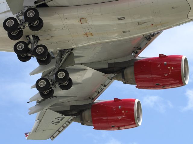 Airbus A340-600 — - Close up detail of the A340-600, main landing gear, wing trailing and leading edge lift devices and the port side Rolls Royce Trent 500 engines.