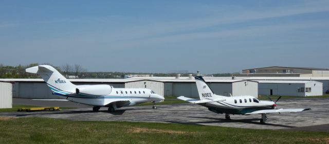 Socata TBM-700 (N9EE) - Catching some tarmac time is this 2003 Socata TBM-700 in the Spring of 2022. A Citation X also catches some down time.